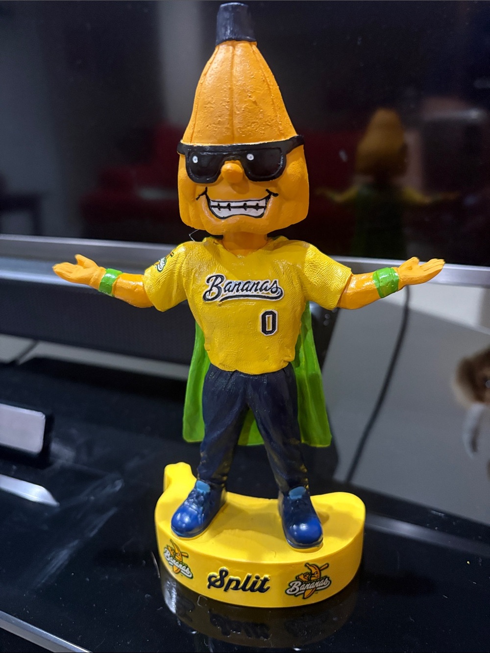 Savannah Banana bobblehead Mascot Figure with Green Cape and Blue Shoes